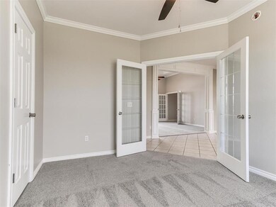 Unfurnished bedroom featuring crown molding, frenc
