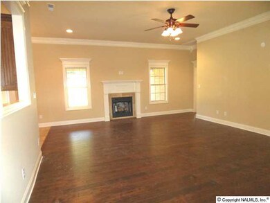 Family room has 10 foot ceilings, hardwood flooring, ceiling fan, gas logs in fireplace, recessed lighting.