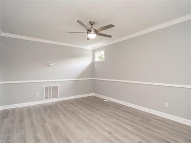 Spacious living room with new flooring, fresh paint and new fixtures.