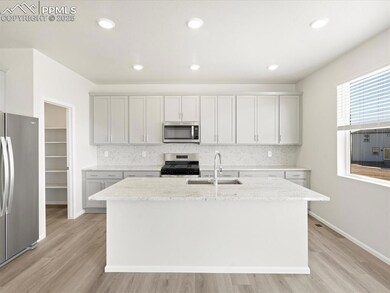 Kitchen featuring a sink, tasteful backsplash, app