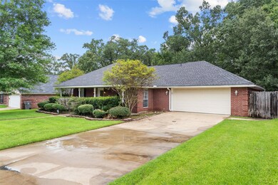 View of front facade featuring a garage and a front lawn