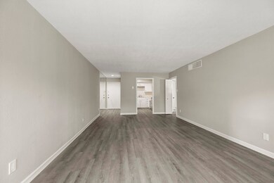 Another view of the living room leading into the k