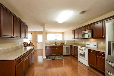 The kitchen is where friends and family always gather.  There is plenty of room for all in this wonderful kitchen. Oven has been replaced with stainless.