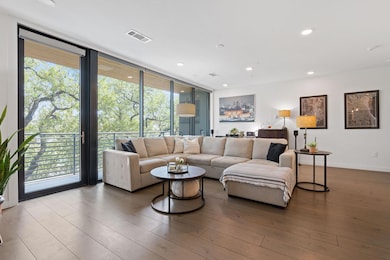 Living room featuring expansive windows, wood fin