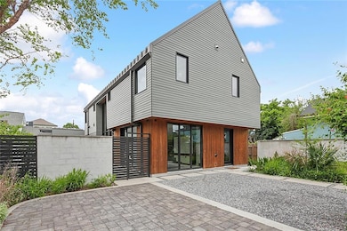 Paved parking and front yard with native plants with self-watering gutter grow system. With Electric car plug, plug can be use also for a portable gas generator that will produce electricity to the full house.
