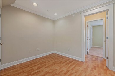 Unfurnished room with crown molding, baseboards, l