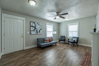 Living area with dark hardwood / wood-style floors