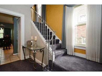 Living Room. A wrought iron balustrade is found al