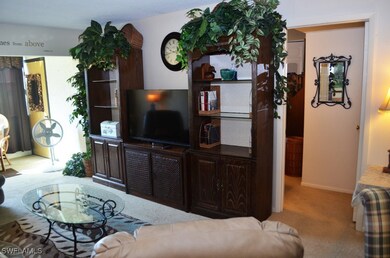 Living area with carpet and baseboards
