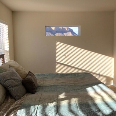 Master with window framed view of cliffs