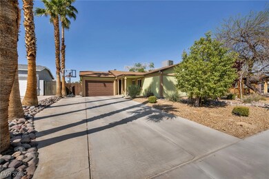 View of front facade with fence, stucco siding, a