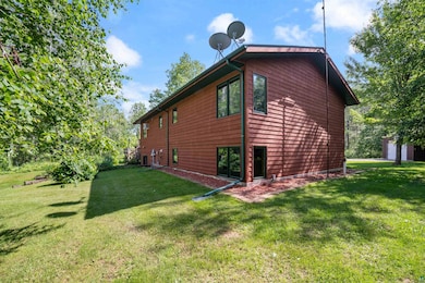 View of side of home with a yard