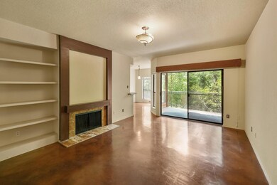 Unfurnished living room with a tile fireplace, bu