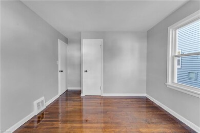 Spare room with dark wood-type flooring