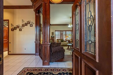 Foyer with light tile patterned floors, ceiling fa