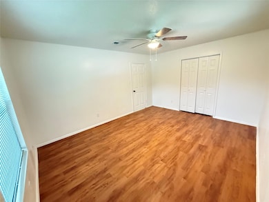 Unfurnished bedroom with a closet, a ceiling fan,