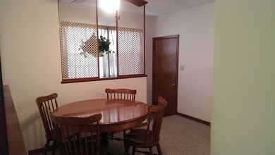 Looking towards basement steps and garage door.
