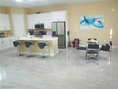 Kitchen featuring a breakfast bar, an island with