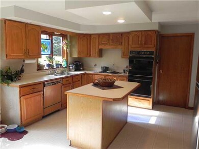 Kitchen spacious eat in kitchen with eating area,center island, lots of cabinets,new stainless steel refrigerator