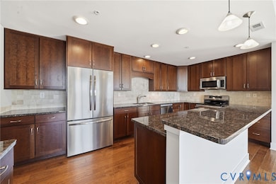 ss appliances, induction oven (gas line is run), walk in pantry, large island, ample granite countertop space, recessed lighting