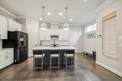 Light and bright kitchen on the first floor with an island for additional seating.