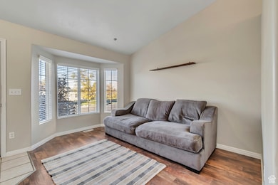 Living area featuring lofted ceiling and wood finished floors