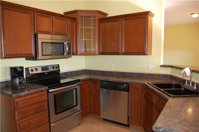 Kitchen has lots of cabinets and stainless steel appliances.  All appliances remain.