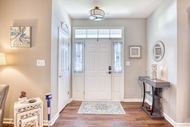 Entrance foyer featuring a textured ceiling and da