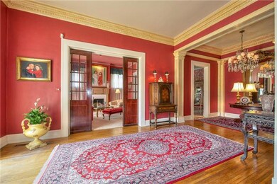 A formal living room adjacent to the formal dining room. Notice the massive pocket doors.