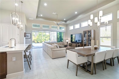 Open Concept view of dining & living room towards pool