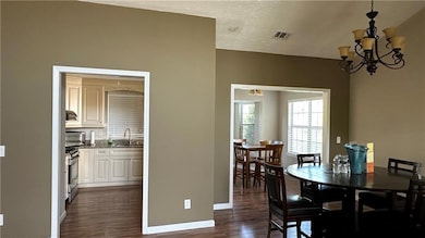 Dining area featuring visible vents, baseboards, a