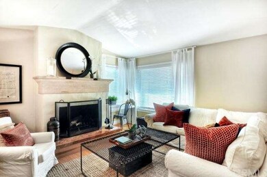 Cozy up to the fireplace in this light filled livi