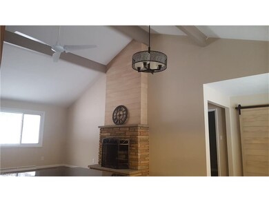 The incredible fireplace and vaulted main living a