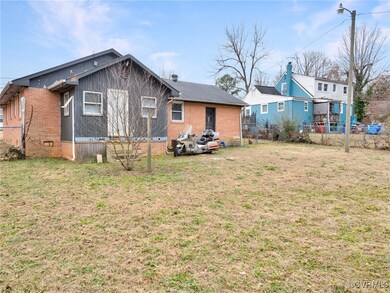 Back of property featuring a yard