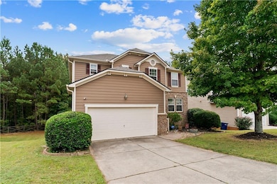 Traditional-style house featuring brick siding, a front yard, and driveway
