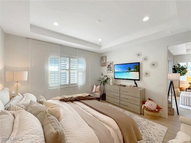 Primary Bedroom with a raised ceiling and recessed
