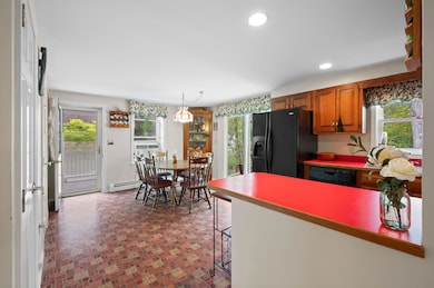 Open concept kitchen & dining area with a slider leading to the back deck