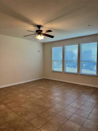 Unfurnished room featuring a textured ceiling and ceiling fan