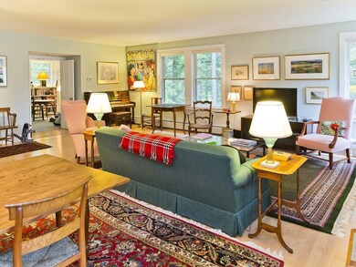 The living room, large windows look...