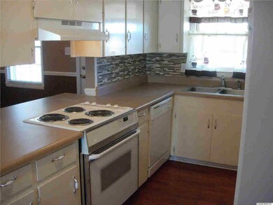 Kitchen with new backsplash, light fixture and paint