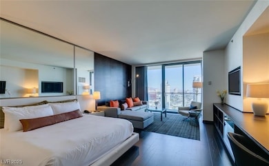 Bedroom featuring dark wood-style floors and expan