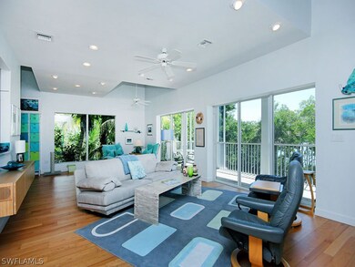 Open Living room leading to screened lanai