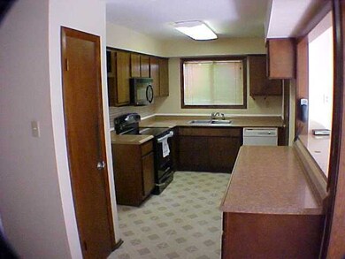 Well lighted Kitchen has a new smooth top range an