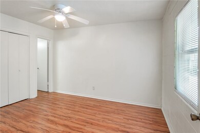 Unfurnished bedroom featuring multiple windows, li