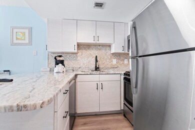 Kitchen with sink, stainless steel appliances, tas