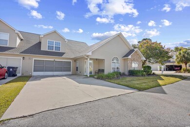 View of front of property featuring driveway, roof with shingles, a garage, and a front yard