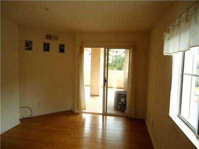 2nd bedroom with sliding door onto balcony.