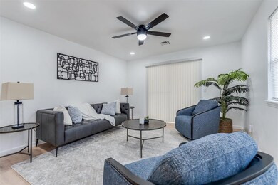 Living area with recessed lighting, a ceiling fan,