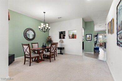 Dining room with a chandelier, carpet, visible ven