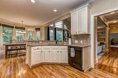 Gourmet kitchen has a sitting bar and custom cabin